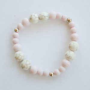 glass pink and white marble pretty-n-pink bracelet laying flat on a white background.