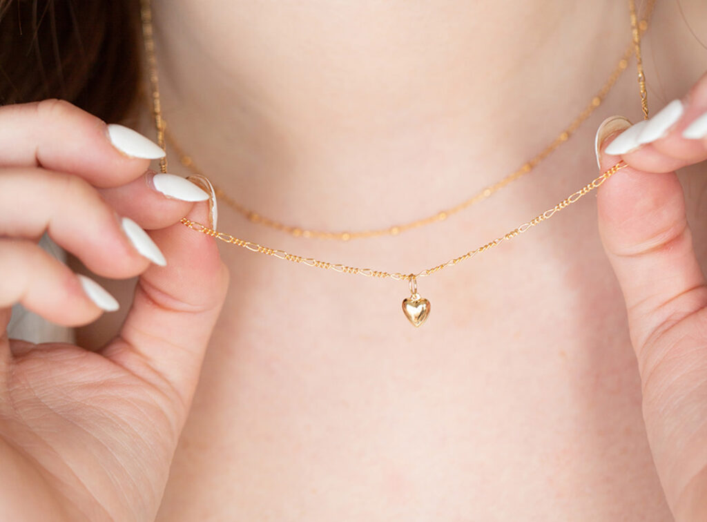 young woman wearing permanent jewelry necklace