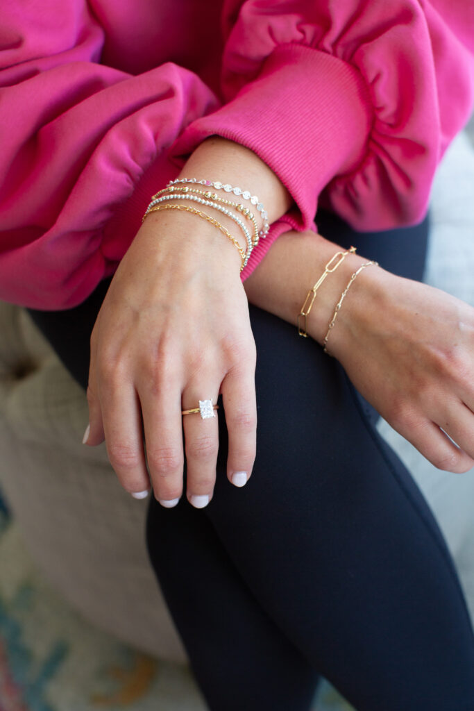 Close-up of custom permanent bracelets near me from EverJoy Permanent Jewelry, showcasing a 14k gold-filled chain with personalized charms.