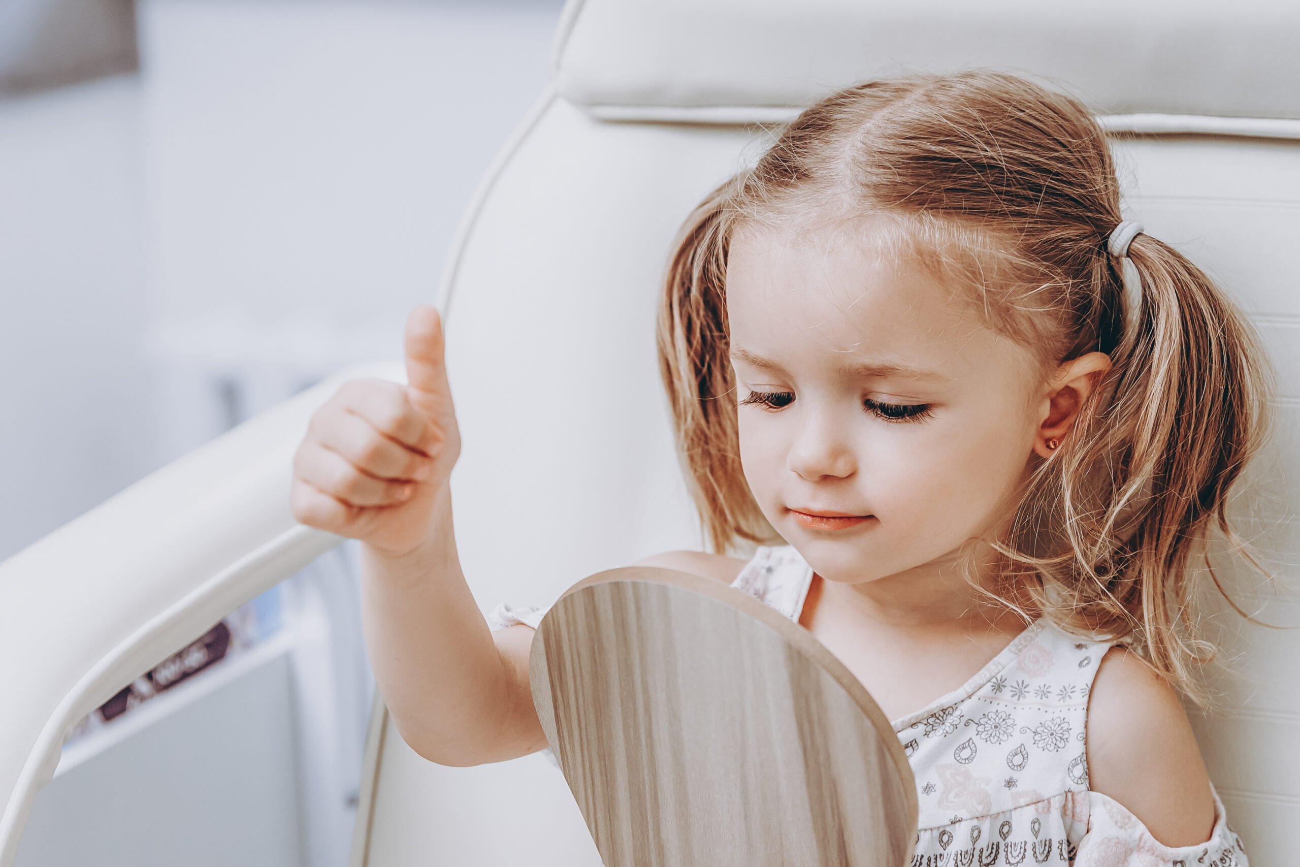 Close-up of a happy kid after getting her ears pierced at EverJoy Jewelry in Indianapolis. A fun kid package is just what every mom wants for a first-time piercing for her child.